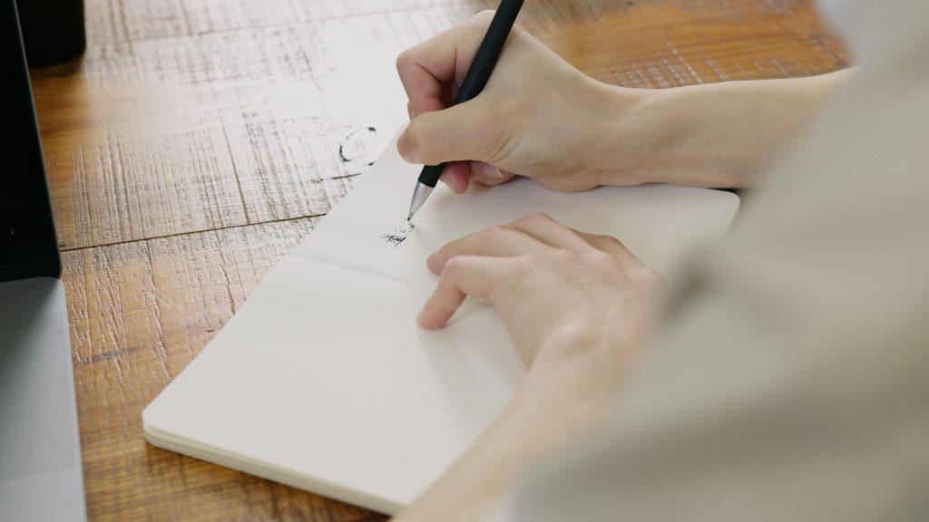 une femme qui écrit sur un carnet