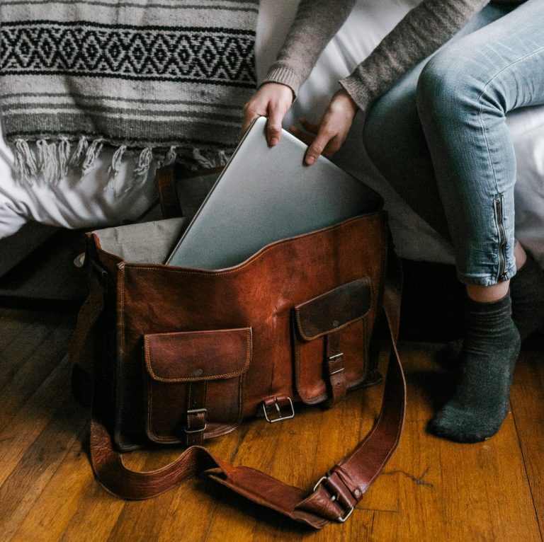une femme qui range son ordinateur dans son sac